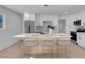 Modern kitchen with white cabinets, island, and stainless steel appliances at 2116 Fuller Rd, Las Vegas, NV 89108