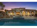 A luxurious home with a pool, spa, outdoor fireplace, arched columns, and a scenic view at 22 Rue Grimaldi Way, Henderson, NV 89011