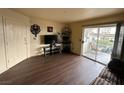 Living room featuring dark laminate floors and access to patio at 3550 Bay Sands Dr # 1017, Laughlin, NV 89029