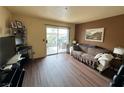 Living room with sofa, TV, and access to balcony at 3550 Bay Sands Dr # 1017, Laughlin, NV 89029