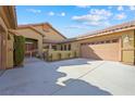Tan colored house with attached garage and gated entry at 3757 Brittany Nicole Ct, Las Vegas, NV 89139