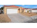 Single-story house with attached garage and well-maintained front yard at 4002 Extenso Dr, North Las Vegas, NV 89032