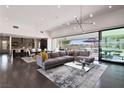 Open floor plan living room with grey sectional sofa and glass coffee table at 4135 N Durango Dr, Las Vegas, NV 89129