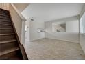Living room with tile floors and staircase at 4770 Topaz St # 77, Las Vegas, NV 89121