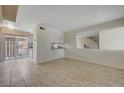 Bright living room with tile floors and kitchen view at 4770 Topaz St # 77, Las Vegas, NV 89121
