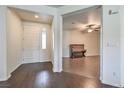 Open entryway with wood-look floors, leading to living room with piano at 4880 Da Vinci Way, Pahrump, NV 89061