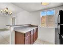 Kitchen boasting granite countertop space, wooden cabinets, and an adjacent dining area for easy entertaining at 5493 Indian River Dr # 383, Las Vegas, NV 89103