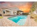 Backyard pool with brick patio and desert landscaping, perfect for outdoor entertaining at 5904 Negril Ave, Las Vegas, NV 89130