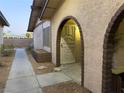 Front view of the property showing a walkway to an arched entryway at 5905 Smoke Ranch Rd # A, Las Vegas, NV 89108