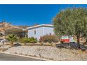 A quaint single-story home with covered parking and low-maintenance landscaping against the backdrop of scenic mountains at 648 Mount Blackburn Ln, Boulder City, NV 89005