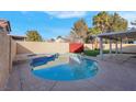 Relaxing kidney-shaped pool and spa in a backyard setting at 6586 W Mesa Vista Ave, Las Vegas, NV 89118