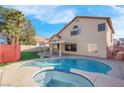 Inviting kidney-shaped pool with a spa and covered patio at 6586 W Mesa Vista Ave, Las Vegas, NV 89118
