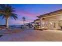 Elegant outdoor living space featuring a spa, patio, and palm trees with views of the evening sky at 942 Villa Grande Way, Boulder City, NV 89005