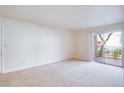 Spacious living room with neutral carpeting and access to a balcony at 5060 Indian River Dr # 377, Las Vegas, NV 89103