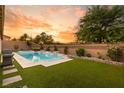 Relaxing pool and spa area with artificial turf and a built-in grill at 10086 Mountain Foothills Ave, Las Vegas, NV 89149