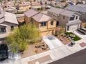 An aerial view of a house with manicured landscaping, and a spacious driveway in a residential area at 1012 Water Cove St, Henderson, NV 89011