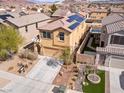 Aerial view of a two-story house with solar panels, landscaped yard, and a driveway at 1012 Water Cove St, Henderson, NV 89011