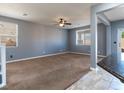 Empty living room featuring gray walls, carpet floors, and a well-lit open space at 1012 Water Cove St, Henderson, NV 89011