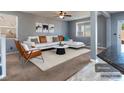 Bright living room with modern gray walls, white L sofa, and neutral carpet at 1012 Water Cove St, Henderson, NV 89011
