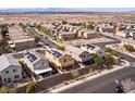 Wide aerial view of neighborhood featuring homes with solar panels and desert landscaping at 1012 Water Cove St, Henderson, NV 89011