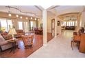 Spacious living room with hardwood floors and a view into the dining area at 10718 Del Rudini St, Las Vegas, NV 89141