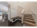 Well-lit entryway with hardwood floors, a coat rack and a staircase with safety gate at 11290 Hazel Rock St, Las Vegas, NV 89179