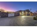 Charming home with a gated entrance and ample parking space at twilight at 1202 S Rancho Dr, Las Vegas, NV 89102