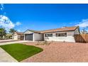 Newly landscaped front yard with artificial turf and updated facade at 1700 Breezewood Dr, Las Vegas, NV 89108