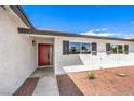 Modern red front door and updated gray shutters at 1700 Breezewood Dr, Las Vegas, NV 89108