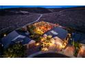 Expansive property with a beautifully lit backyard at night at 2064 Poetry Ave, Henderson, NV 89052