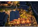 Night view of a home with a putting green and landscape lighting at 2064 Poetry Ave, Henderson, NV 89052