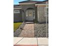 Front entrance with brick walkway leading to a charming home at 2571 Bonano Ct, Las Vegas, NV 89108