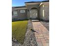 Modern house with arched entryway and manicured lawn at 2580 Bonano Ct, Las Vegas, NV 89108