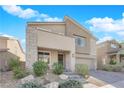 Two-story house with stone accents and landscaped front yard at 2598 Iron Crest Ln, Las Vegas, NV 89138