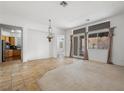 Spacious dining area with tile flooring, chandelier, and views into kitchen at 3020 Via Venezia, Henderson, NV 89052