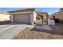 Inviting single-story home with a two-car garage and low-maintenance desert landscaping at 3025 Seaford Peak Dr, Henderson, NV 89052