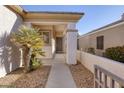 Covered front porch with a desert landscape design, offering a welcoming entrance at 3025 Seaford Peak Dr, Henderson, NV 89052