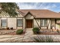 Front view of a charming house with double wooden doors and well-maintained landscaping at 3988 Salisbury Pl, Las Vegas, NV 89121