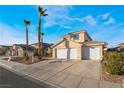 Two-story house with a two-car garage and palm trees at 4116 W Delhi Ave, North Las Vegas, NV 89032