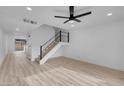 Bright living room featuring light wood-look flooring and a modern ceiling fan at 4182 Mississippi Ave, Las Vegas, NV 89103