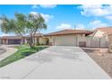 Single story home with a two-car garage and well-manicured lawn at 5423 Arturo Ct, Las Vegas, NV 89120