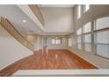 Two-story living room with hardwood floors and high ceilings at 6504 Birdcall St, North Las Vegas, NV 89084