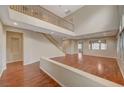 Two-story living room with hardwood floors and high ceilings at 6504 Birdcall St, North Las Vegas, NV 89084