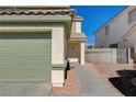 Green garage door and walkway to the home's entrance at 6536 Elk Creek Ln, Las Vegas, NV 89156