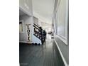 Open-concept entryway showcases sleek tile flooring and staircase with rod iron railing at 7329 Restful Springs Ct, Las Vegas, NV 89128