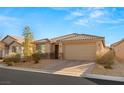 Single story home with a two-car garage and landscaped front yard at 8113 Brown Clay Ave, Las Vegas, NV 89113