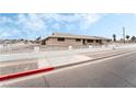 Brick house with a white fence and landscaped yard at 845 Palo Verde Dr, Henderson, NV 89015