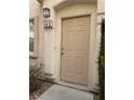 Beige front door with a simple design and address number 103 at 8800 Roping Rodeo Ave # 103, Las Vegas, NV 89178