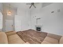 Living room featuring hardwood floors, fireplace, and high ceilings at 9008 Rusty Rifle Ave, Las Vegas, NV 89143