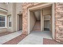 Exterior entrance with stone accents leading to stairs and storage at 10809 Garden Mist Dr # 2093, Las Vegas, NV 89135